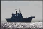 A Royal Navy warship with a small motor boat closing - risk of collision exists