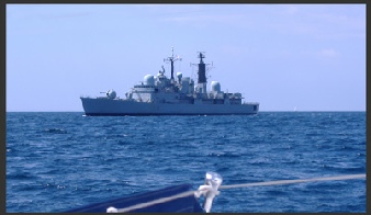 Warship overtaking a sailing vessel - about 1 cable distant