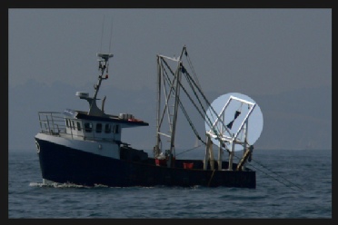 A vessel trawling (shows signal for vessel engaged in fishing)ing)