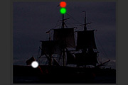 A large vessel under sail showing optional lights on her mast